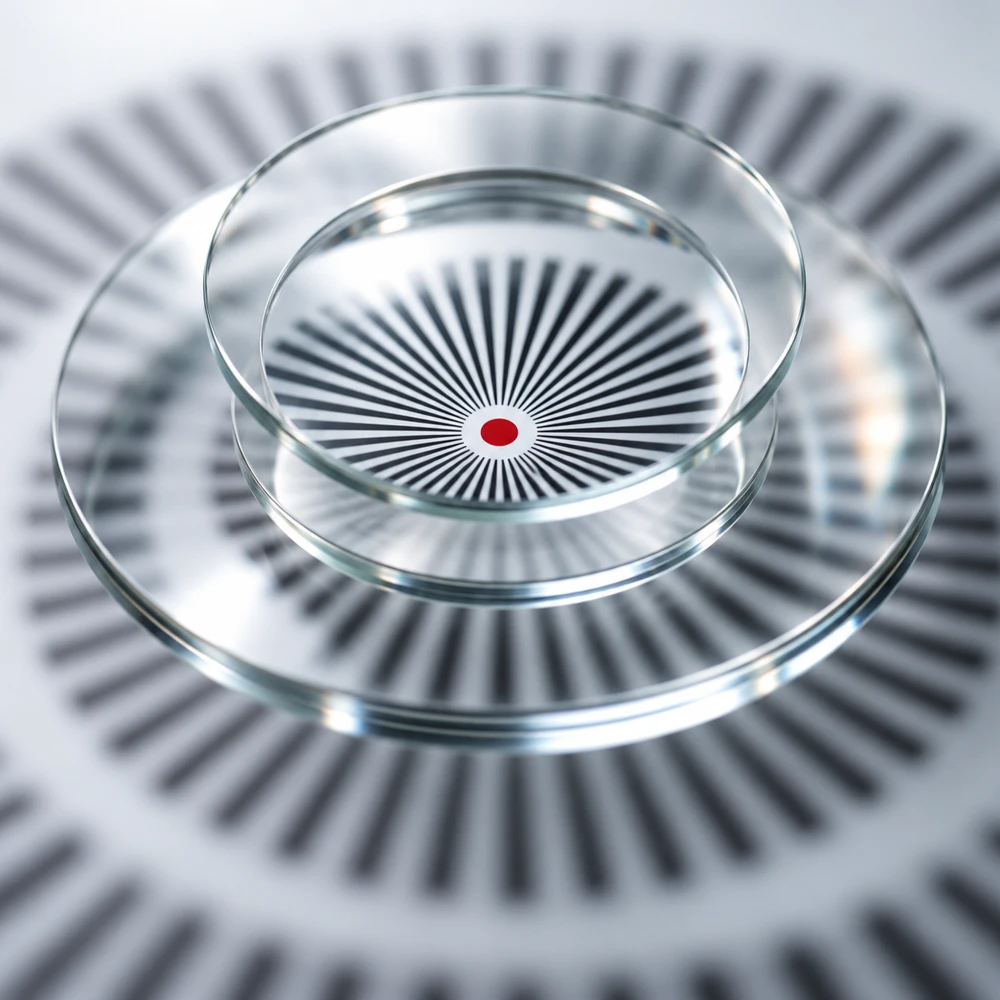 Stacked glass lenses resolving a radial pattern to a single red point